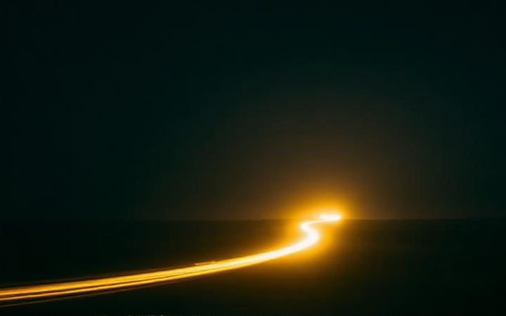 A warm trail of light moving through darkness